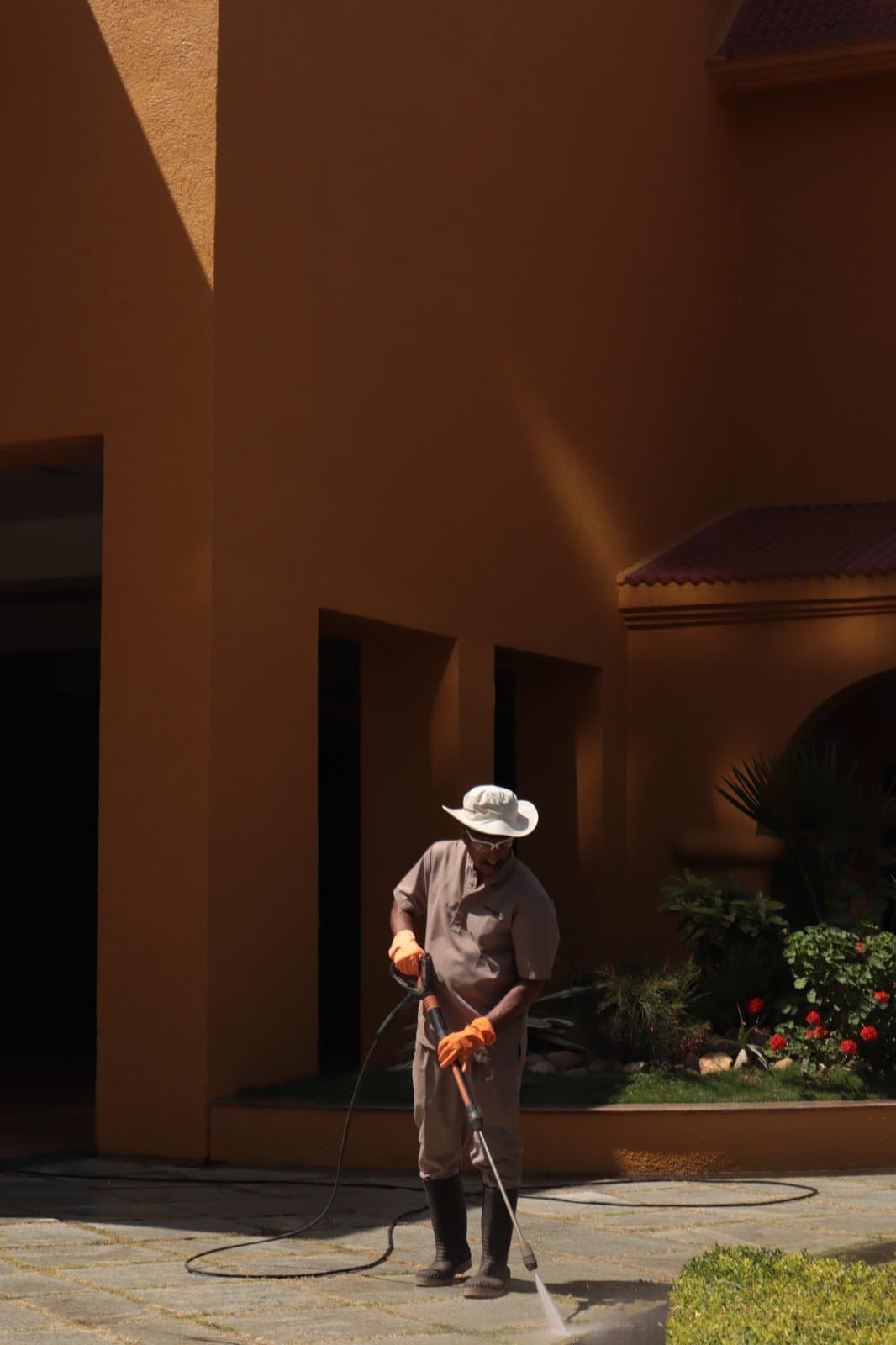 Pressure washing a sidewalk with a wand